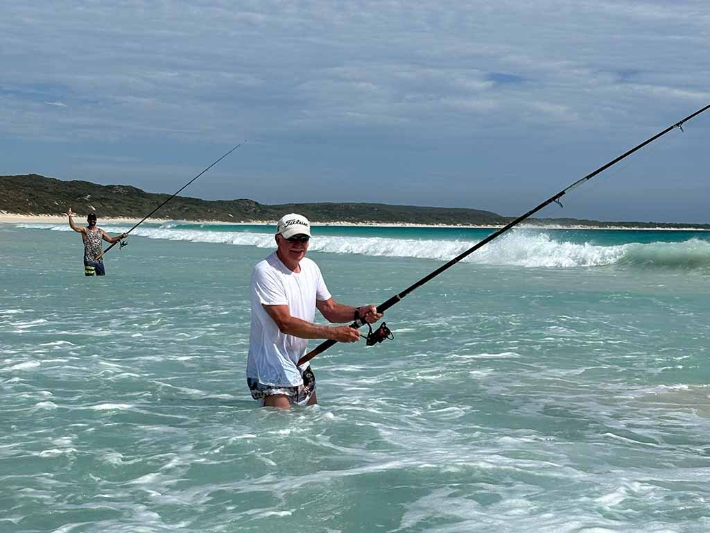 Boranup Beach fishers in waist deep ocean water.