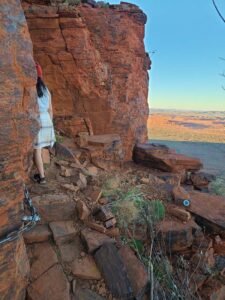 Female hiker on turn while hiking up Mount Bruce in Karijini National Park