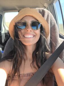 Attractive woman in front seat of 4WD with large smile on her face