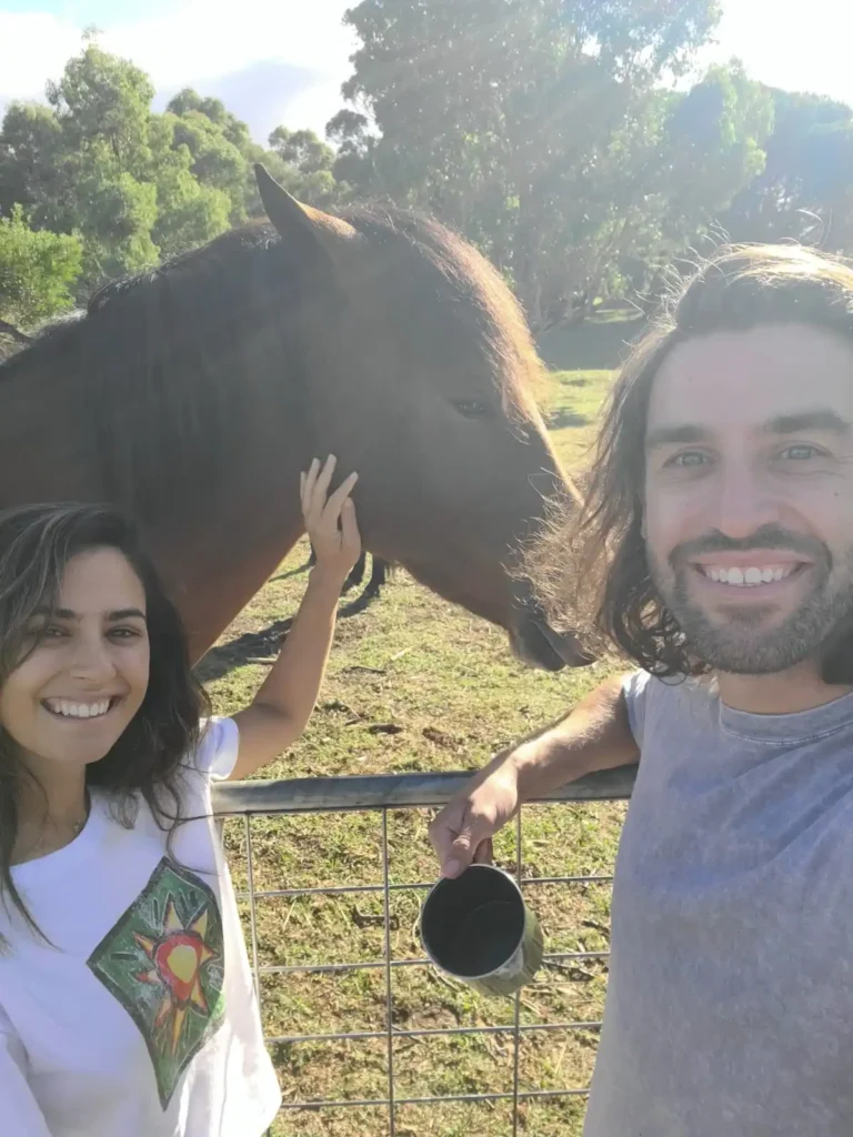 Two campers with a horse at Fair Harvest campground in Margaret River, WA.