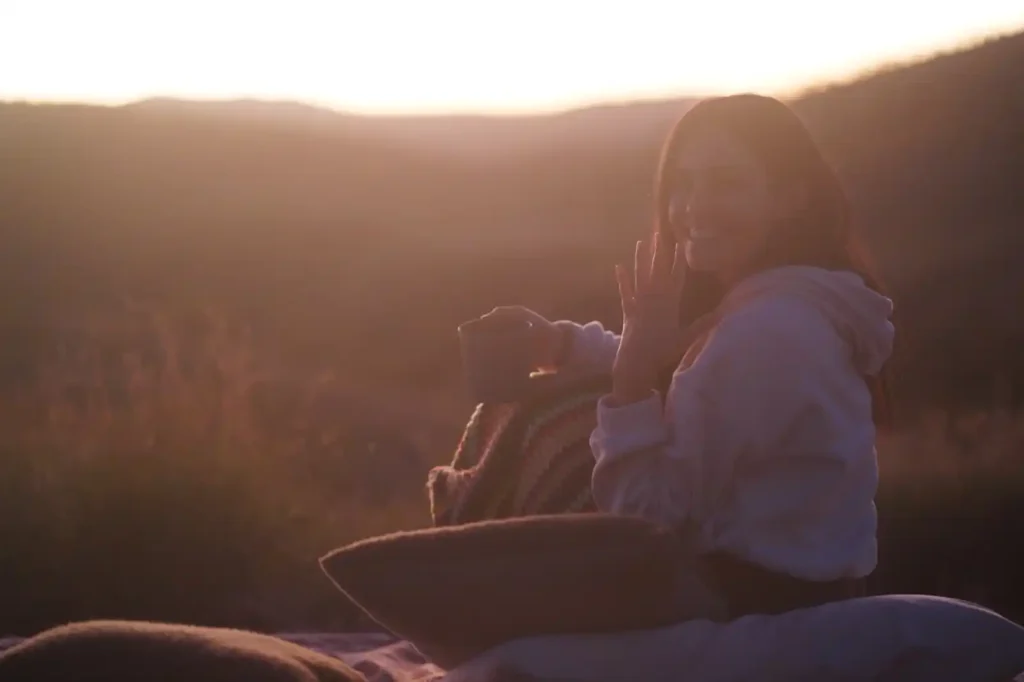 Female camper holding up wedding ring after proposal while camping near Mount Bruce at Albert Tognolini Rest Area, Karijini National Park.