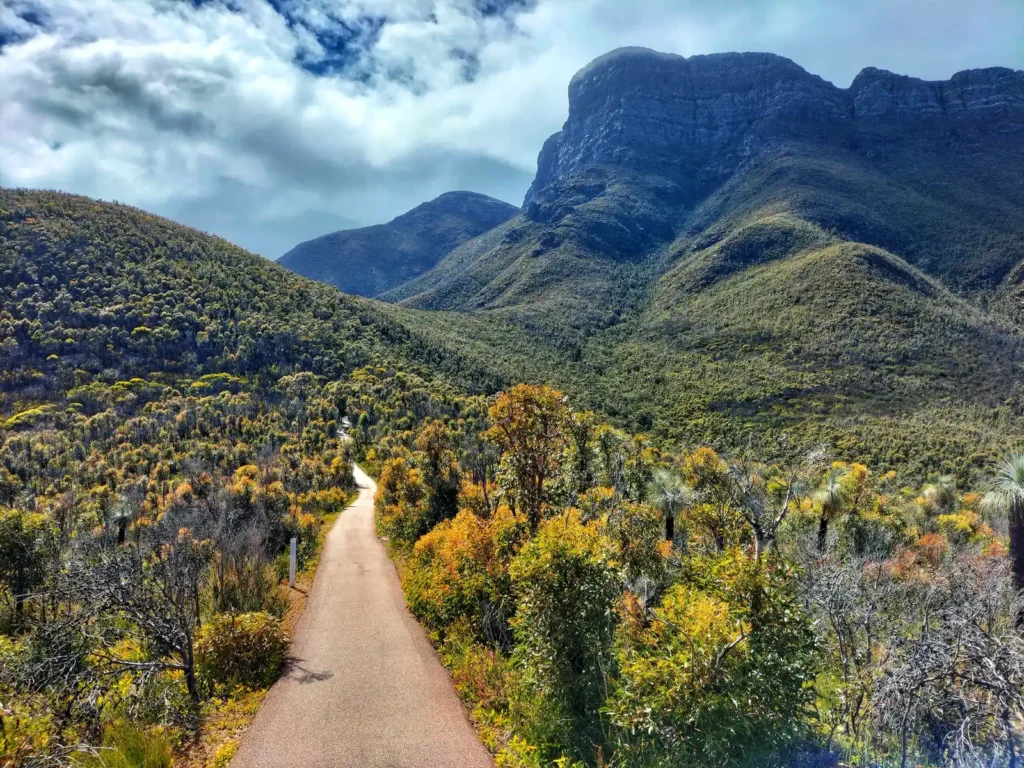 Pathway to Bluff Knoll from carpark, cloudy skies above and Bluff Knoll peak in distant background.