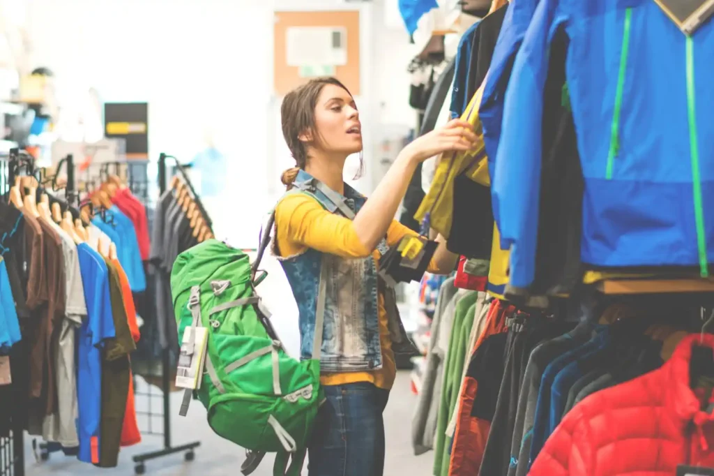 Female hiker looking at hiking gear in camping store in Perth.