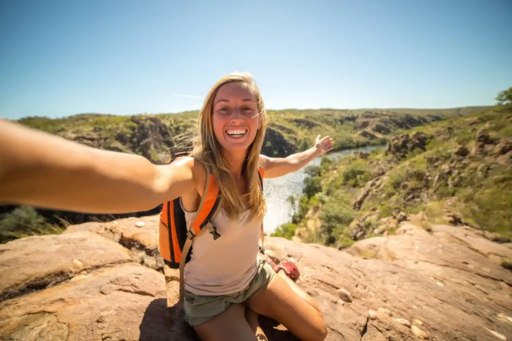 Female hiker with arms out wide during summer hike in WA.