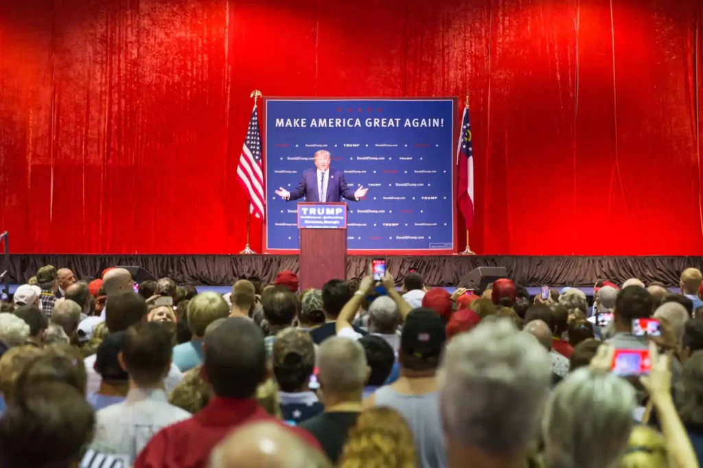 Trump in front of large audience proclaiming gallium resources from West Australia's resource-rich forests.